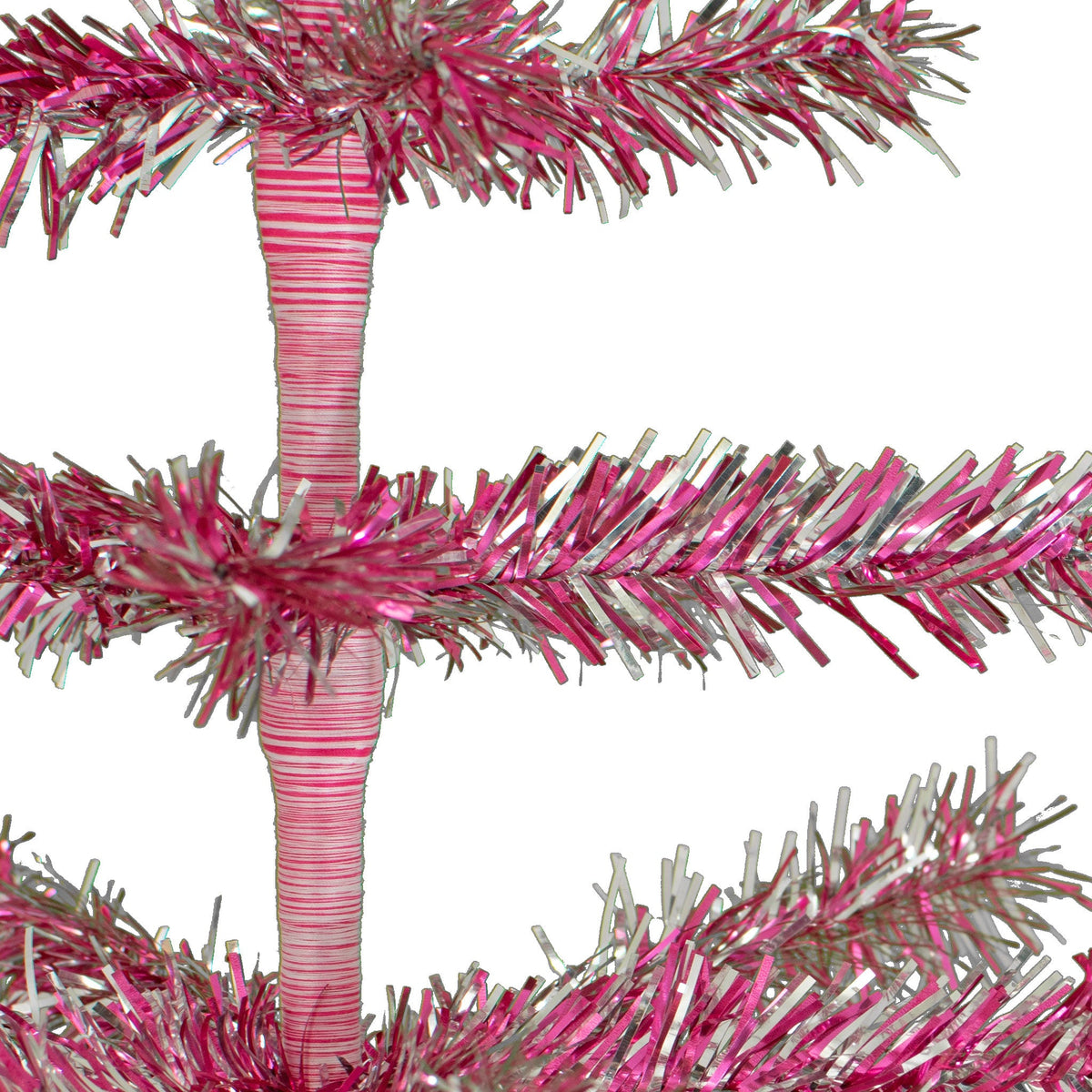 Firework Tinsel Brush: Lee Display builds each tree using garlands mixed with multiple colors of tinsel.   Each garland is cut to size and fit onto each row of branches.  Creating a firework tinsel style of metallic and shiny colors.