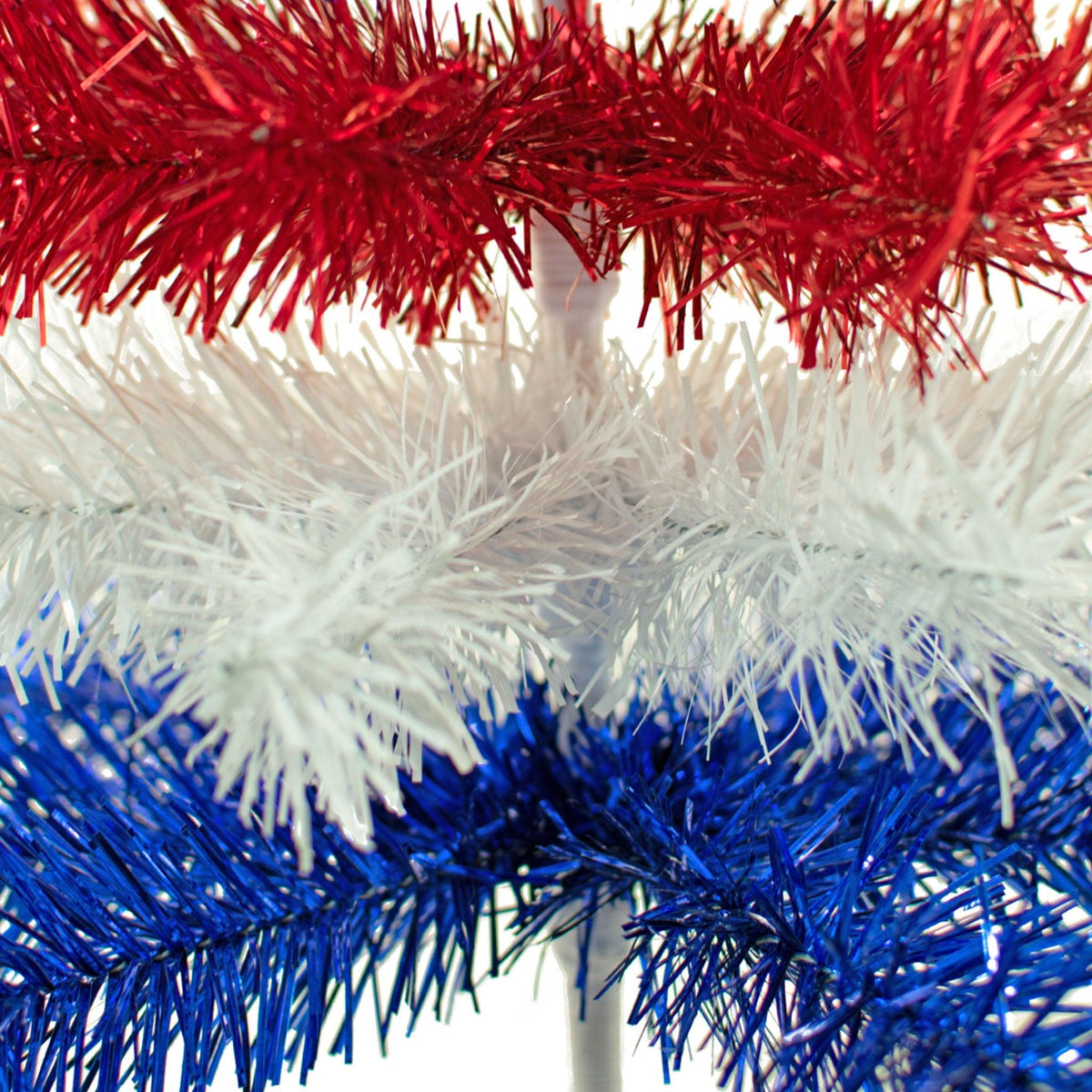 24in tall Red, White, and Blue Layered Tinsel Christmas Trees made by hand in the USA.  Decorate for the holidays with retro 4th of July-themed Trees and start creating your centerpiece now.  Shop for more at leedisplay.com