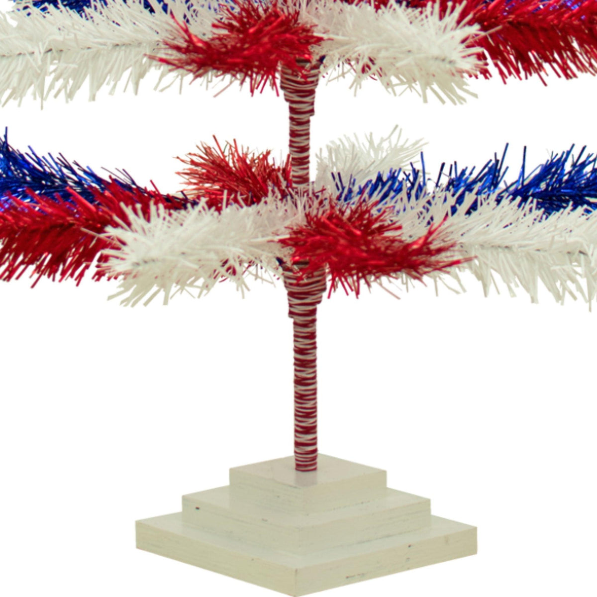Bottom of the 48in Tall Tree comes with a White Tiered tree base. Red White and Blue Mixed Tinsel Christmas Tree on sale at leedisplay.com.