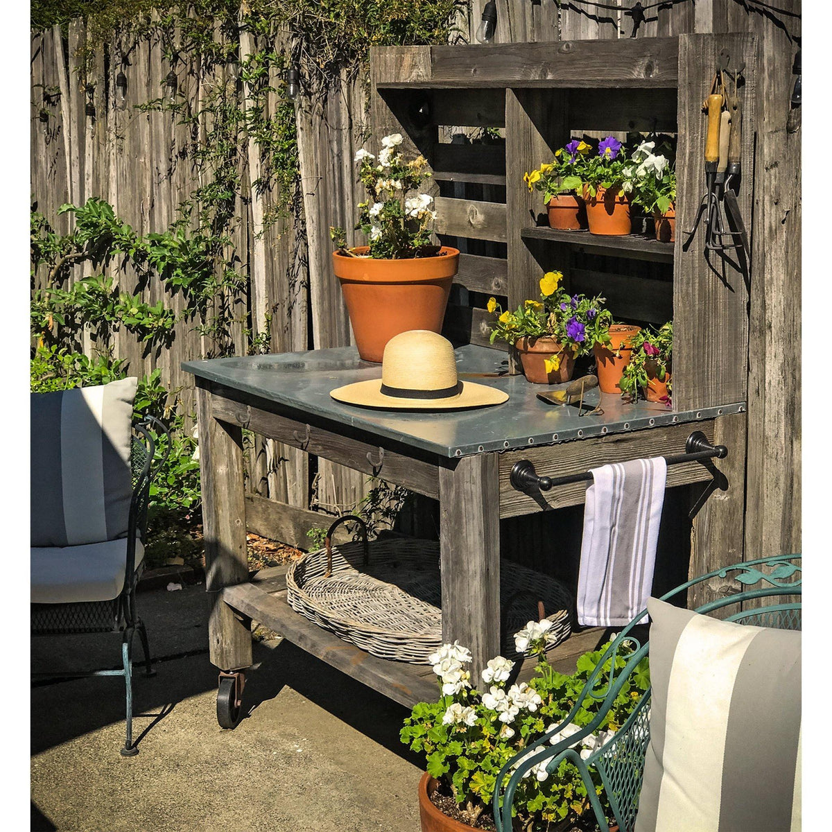 Lee Display's brand new outdoor Redwood Potting Table and Buffet Island sitting outside in the backyard during the springtime.  On sale now at leedisplay.com
