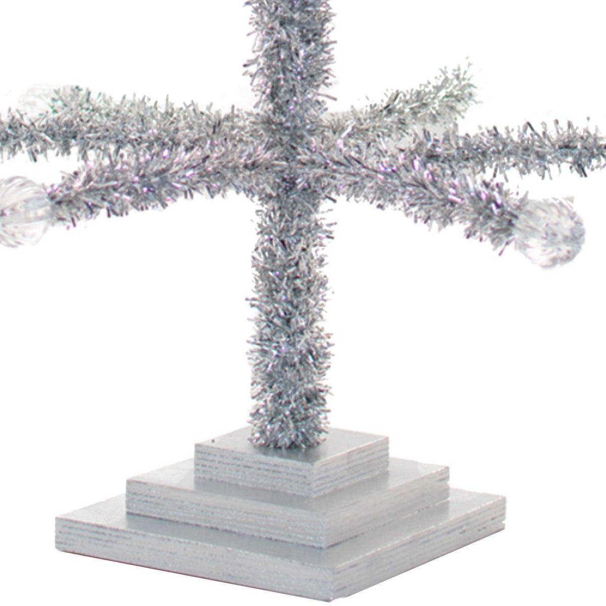The 4FT Silver Merchandising Display Christmas Tree comes with a wooden 3-tiered base.